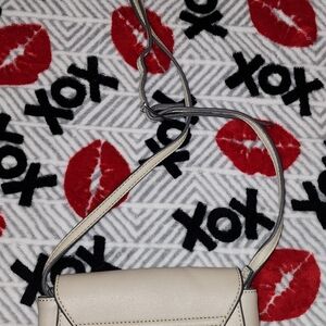 Grayish or maybe a tanish crossbody purse. Has two spots on the backside.